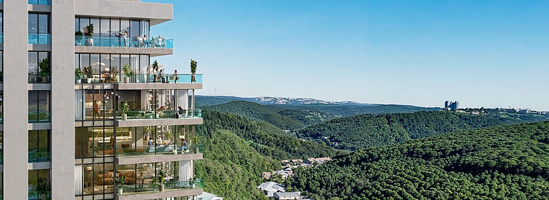 Planted balconies on the corner of a block, the forested valley beyond